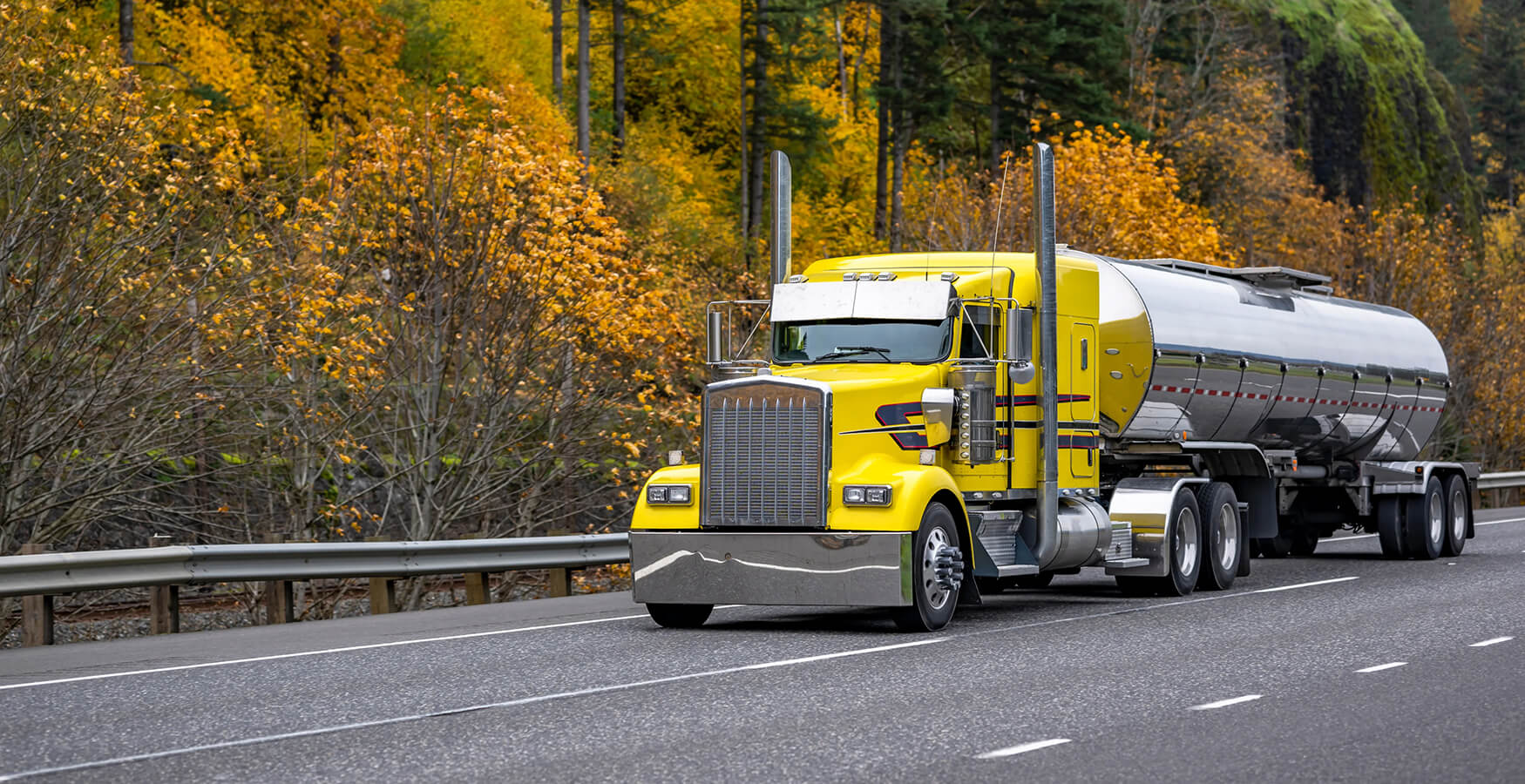 Stainless steel tank on the highway with sleeper cab